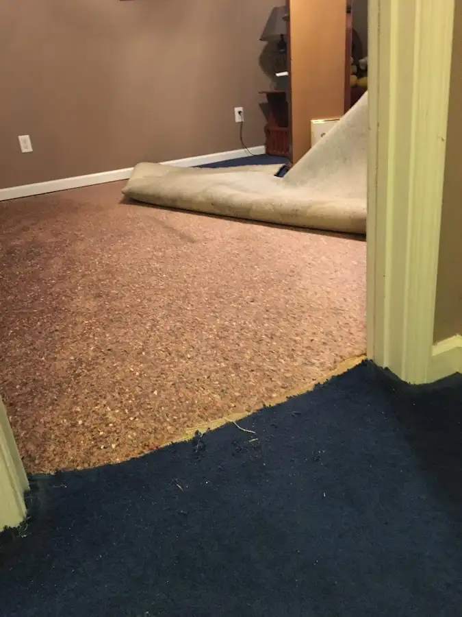 Carpet pad removal revealing water damage during Water Mitigation Services in Chanceford